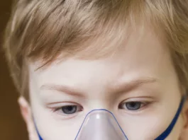 Young boy with oxygen mask for assisted breathing