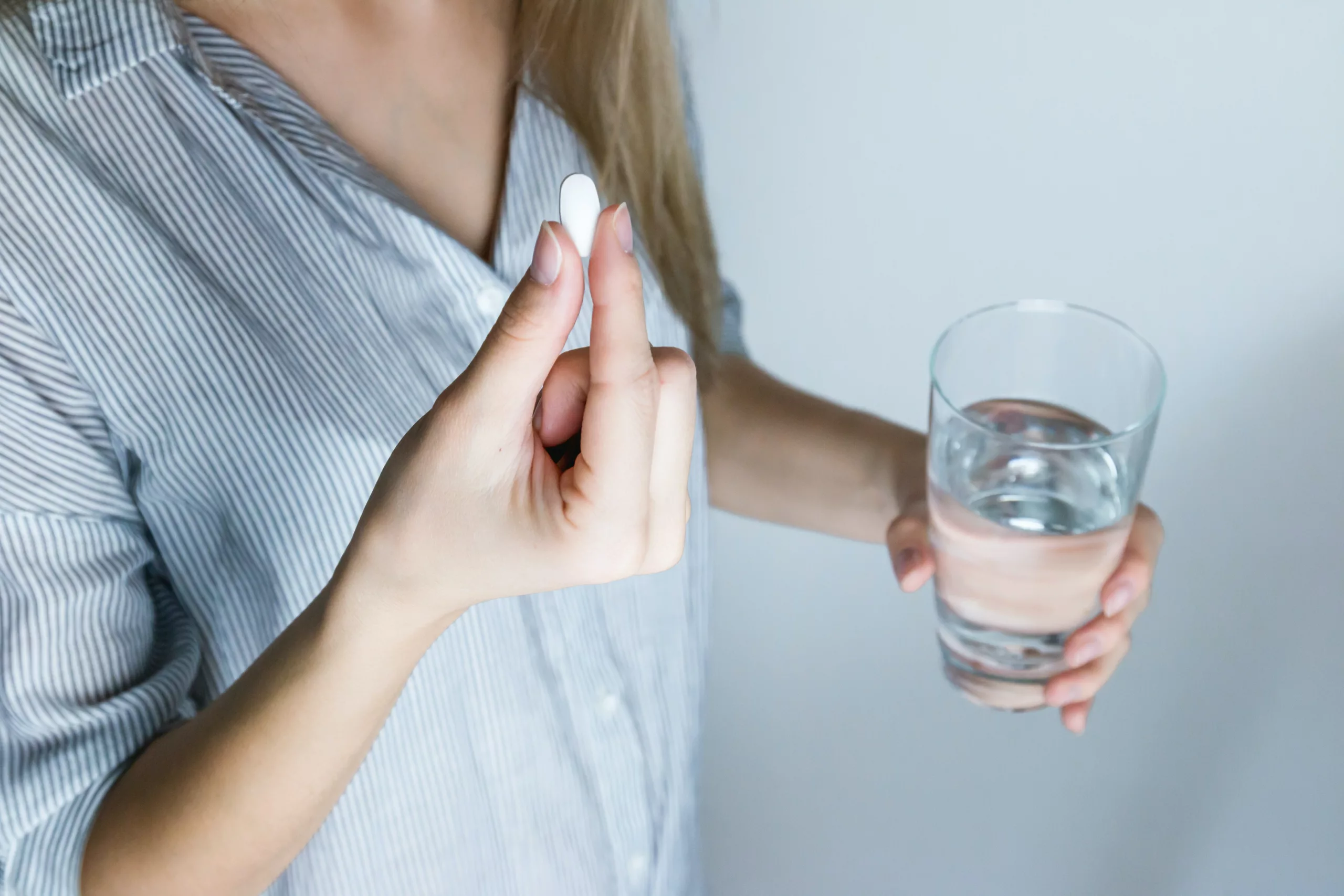 Image of a woman taking medicine