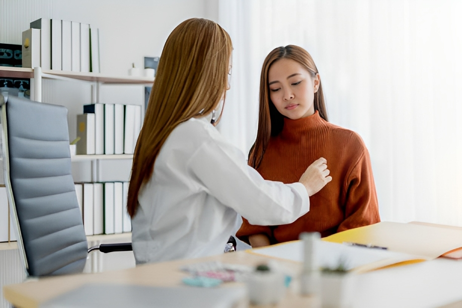 A doctor palpating breast tumor