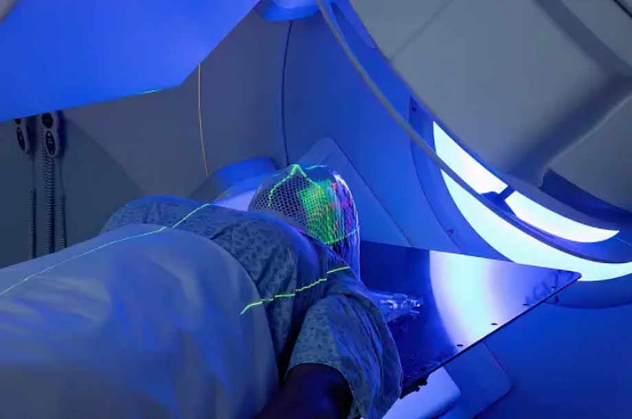 Woman receiving radiotherapy treatment for cancer