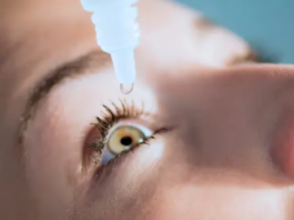 A woman using eye drops to treat xerophthalmia